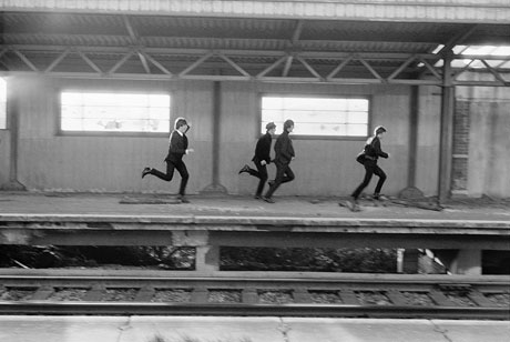 The Beatles during filming of A Hard Day's Night on a train platform, 1964. Photo © David Hurn/ Magnum