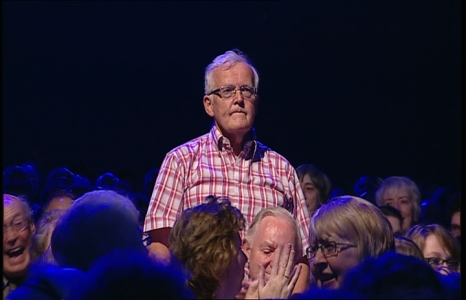 A man stands in the crowd.