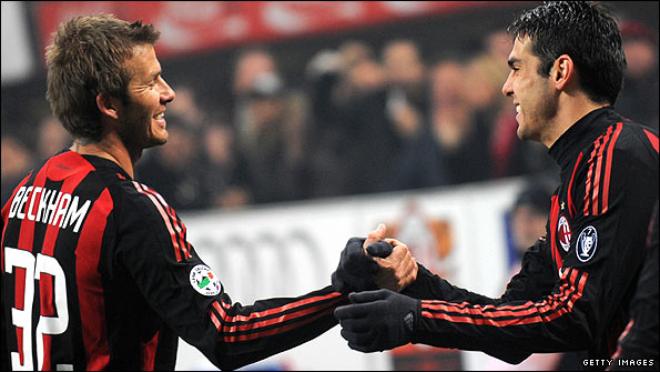 Former Madrid player David Beckham celebrates with former Milan team-mate, Kaka