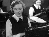 young girls typing in classroom