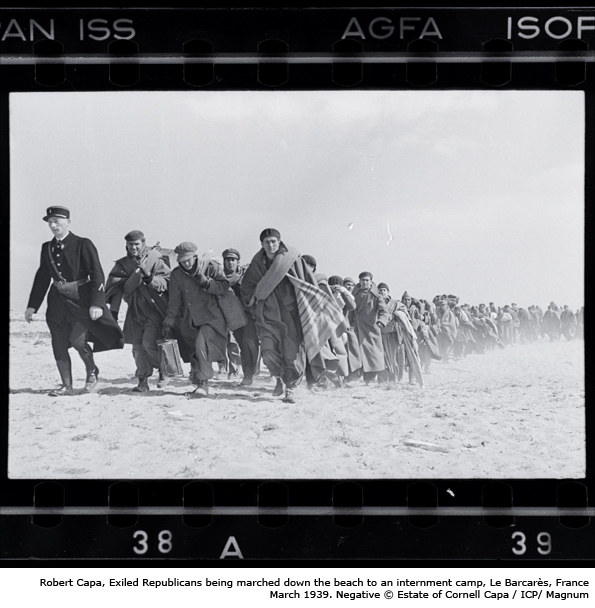 Robert Capa, Exiled Republicans being marched down the beach to an internment camp, Le Barcarès, France, March 1939. Negative © Estate of Cornell Capa / ICP/ Magnum