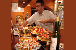 Eating tapas at a bar in the old part of town, San Sebastian, Donostia, Basque Country, Spain