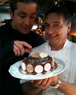 Raymond Blanc with his macaroon cake and cameraman Andy from Raymond Blanc's Kitchen Secrets.