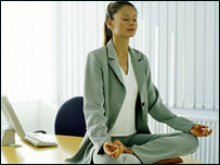 A woman in a Yoga position on a desk!