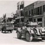 3rd The King’s Own Hussars waiting to take suspects to Rafan Detention Camp Tel Aviv September 1946. Suspects lined up on the road side.