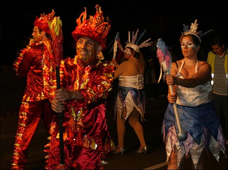 Men dressed as fire walking the parade