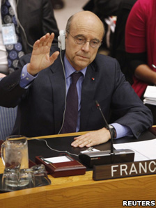 French Foreign Minister Alain Juppe raises his hand to vote in favour of a UN resolution on Libya