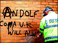 Cleaning graffiti off a wall