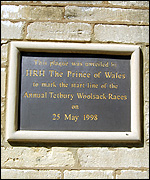 Plaque on the wall of the Crown Inn on Gumstool Hill, marking the official start line of the Tetbury Woolsack Races
