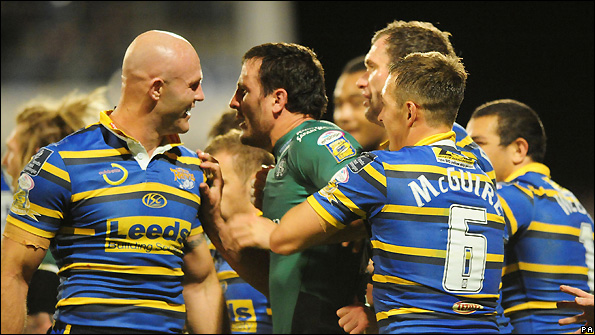 Leeds centre Keith Senior (left) and Saints' Lee Gilmour exchange words