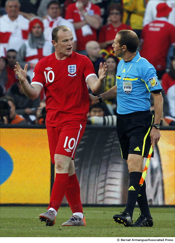 England's Wayne Rooney, left, questions referee Jorge Larrionda