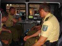 Policemen watching the game in their van