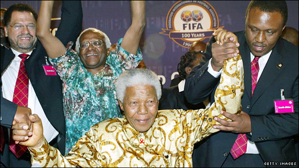 (Left to right): Danny Jordaan, Archbishop Desmond Tutu and Nelson Mandela celebrate being awarded the 2010 World Cup