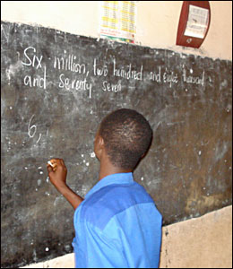 Pupil at Somanya Primary school writes on the board