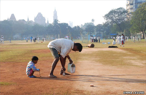 Man painting the crease in cricket match