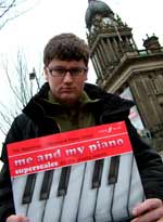 Tom with Fanny Waterman's piano book outside Leeds Town Hall