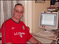 Marco sat at his computer in a football shirt