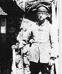 Cassell in full uniform, standing in front of the trench entrance