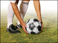 A football player prepares for a free kick