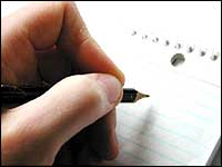 Person writing on a notepad