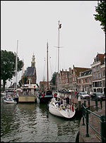 Yacht in Netherlands with man up a mast