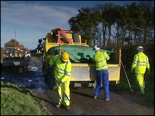 Workers repair pothole damage