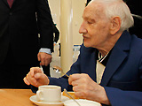 A man eating a meal in a care home.