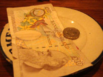 Note and coin on a plate (photo: Jack Gore)