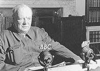 Black and white photograph showing Winston Churchill in a BBC studio wearing a boiler suit