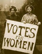 Two Victorian suffragettes holding a 'Votes for women' poster