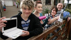 The Davies family featured in 'Changing Lives: Going Green' holding a range of electrical gadgets