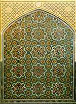 Detailed geometric pattern covers an arch-shaped window