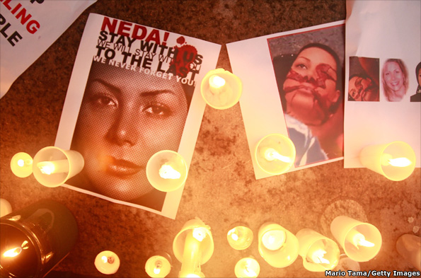Candles are seen with photos of Neda Agha Soltan at a rally in New York, USA