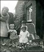 Black and white photo of Frances with her son as a toddler and his friends