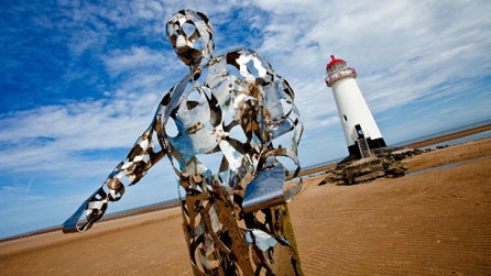 The Keeper sculpture on Talacre beach with Point of Ayr lighthouse in the background. Images courtesy Phil Thomas.