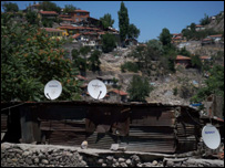 Tin shack with satellite television dishes