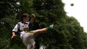 Bláithín Ní Mhurchú demos the hook kick to young player in a park.