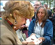 Prunella signing autographs