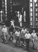 American, Dutch and British bankers being marched back to their offices in 1943