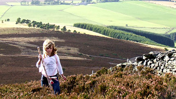 Child walking in the hills