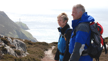 Rosie and Derek en route to Holyhead Mountain with South Stack in the background.