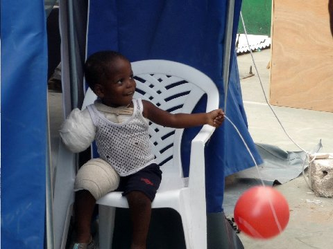 An injured child in Haiti. Photo by Asad Syed.