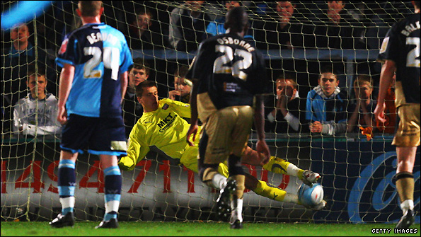 Wojciech Szczesny saves a penalty during Brentford's game against Wycombe