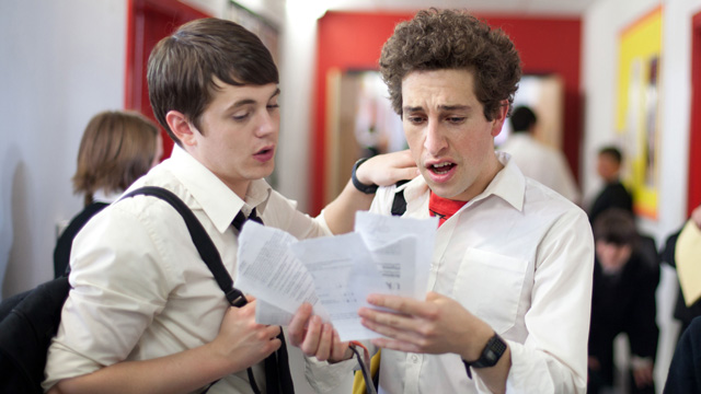 Jamie and Mike reading an exam paper.