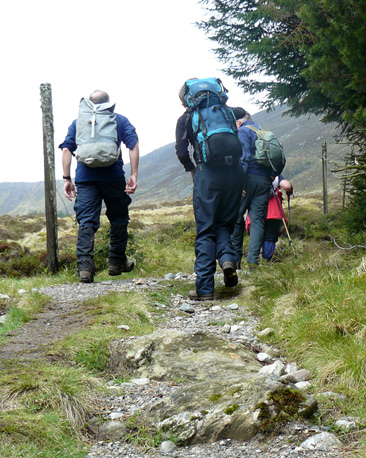 Walkers ascending along the rock path