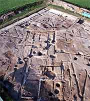 Aerial view of the excavation site showing foundation marks in the mud