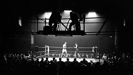 Photograph of cameramen filming a boxing match