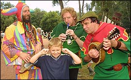 Minstrels entertaining (?) a young boy 