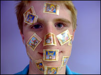 Man with stamps on his face
