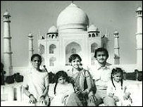 family posing outside Taj Mahal 